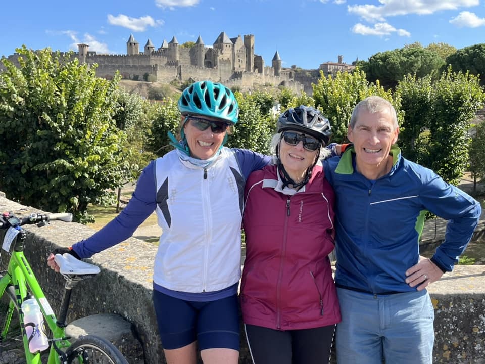 French Cycling Holidays guides with a rider in front of a castle in France